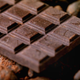 Bittersweet chocolate surrounded by cocoa powder